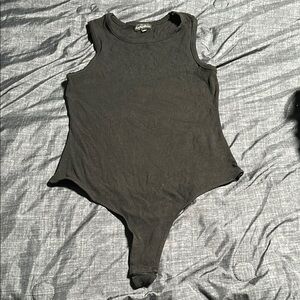 Counterparts Black Bodysuit One Piece with High Cut Design